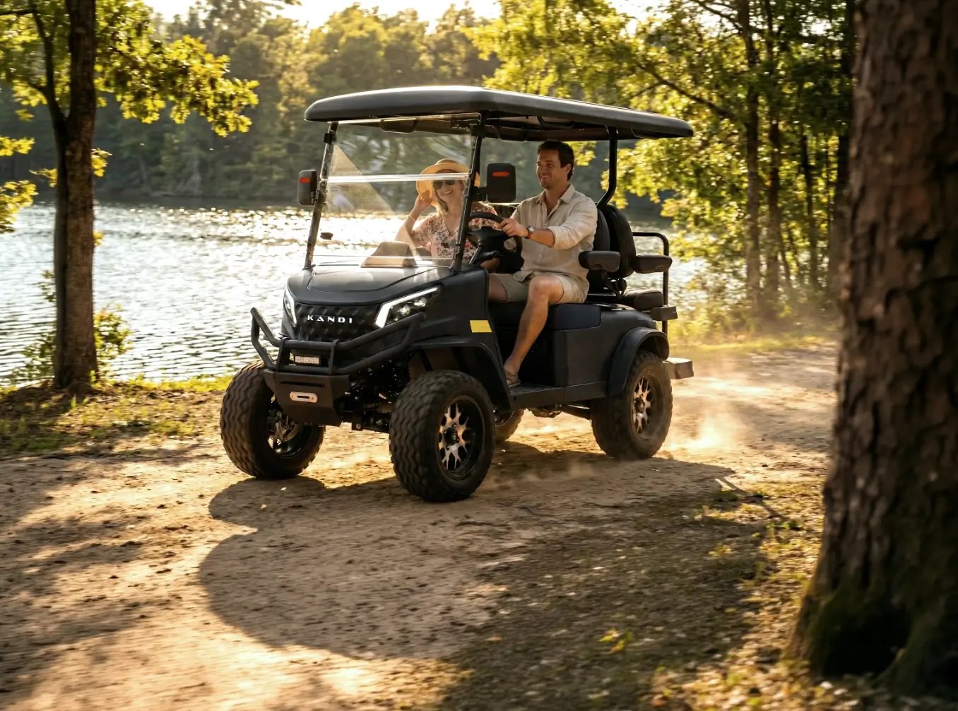 A couple driving a golf cart on a lakeside path